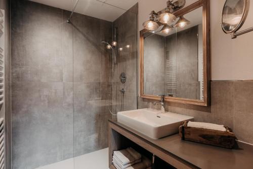 a bathroom with a sink and a mirror at Alpenappartements Cristall in Ehrwald