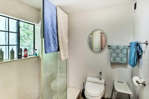 a bathroom with a toilet and a shower and a mirror at Patio and Yard Dtwn Cottonwood Home! in Cottonwood