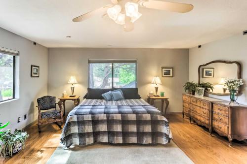 a bedroom with a bed and a ceiling fan at Downtown Cottonwood Home with Hot Tub and Patio! in Cottonwood