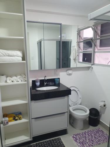 a bathroom with a sink and a toilet at De lucca home Studio in Florianópolis