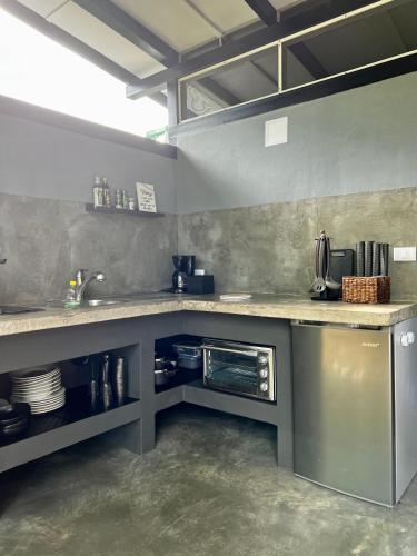 a kitchen with a counter and a sink in it at Whispering Wisdom in Cahuita