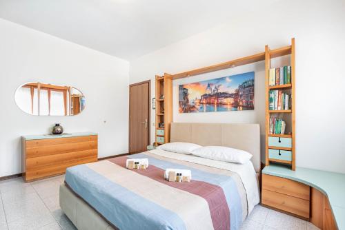 a bedroom with a bed and a book shelf at Residence Fragole Apartment Venice in Campalto