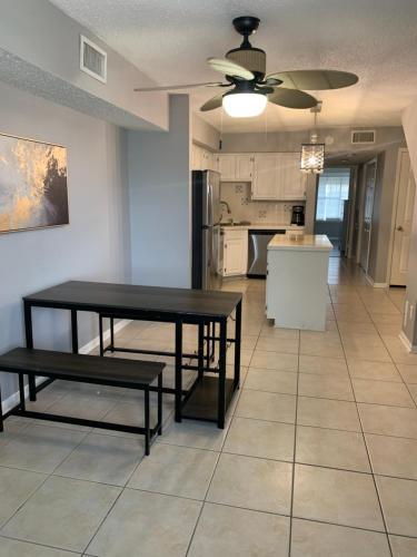 a kitchen with a table and benches in a room at Lovely Condo on the Water in Kemah