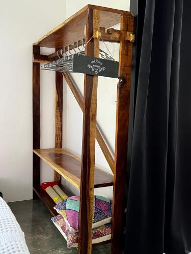 a bunk bed room with a wooden book shelf at Whispering Wisdom in Cahuita