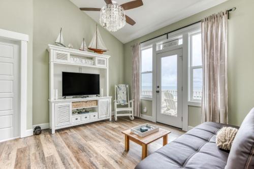 a living room with a couch and a tv at The Bellevue in Lincoln City