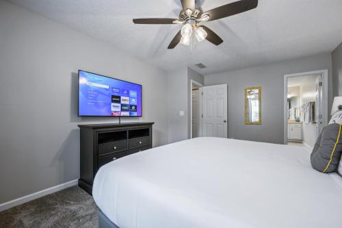 a bedroom with a bed and a flat screen tv at Lots of Hot Spots & Activities Near This Townhome in Cartersville