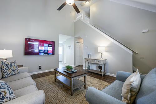 a living room with a couch and a table at Lots of Hot Spots & Activities Near This Townhome in Cartersville