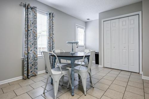 a dining room with a table and chairs at Lots of Hot Spots & Activities Near This Townhome in Cartersville