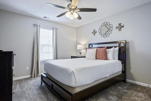 a bedroom with a bed and a ceiling fan at Lots of Hot Spots & Activities Near This Townhome in Cartersville