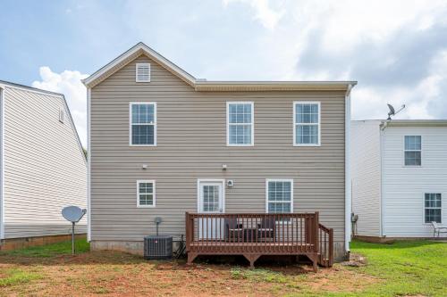 a large house with a bench in front of it at Lots of Hot Spots & Activities Near This Townhome in Cartersville