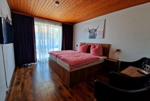 a bedroom with a bed with red pillows and a window at Gästehaus Geist Inkl, Chiemgau Karte in Ruhpolding