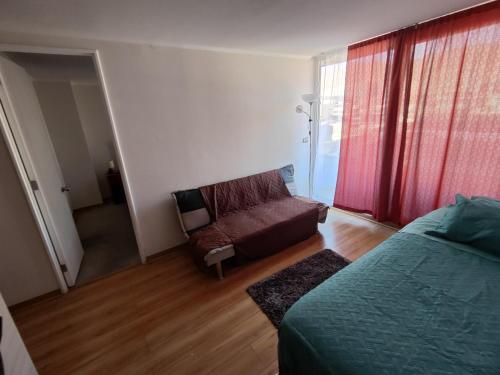 a living room with a bed and a couch at Copernico amoblado 1Dormi. 4 personas 1Est in Antofagasta