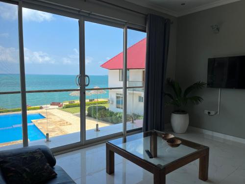 a living room with a view of the ocean at Calamari Beach Resort in Zanzibar City