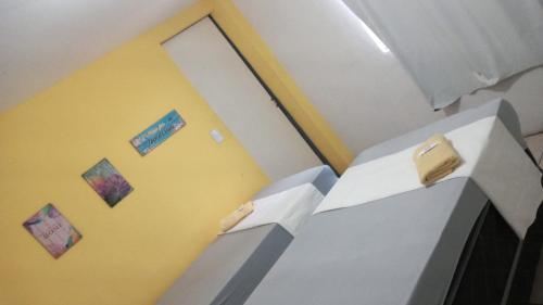 a room with two white boxes with cakes on them at Casa Aeroporto Pousada in Recife