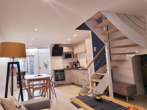 salon ze schodami i kuchnią w obiekcie L'Héméra: Maison au coeur de Barfleur w mieście Barfleur
