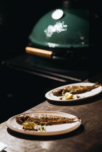 two plates of food on a wooden table at Korona Hotel&SPA in Bukovel