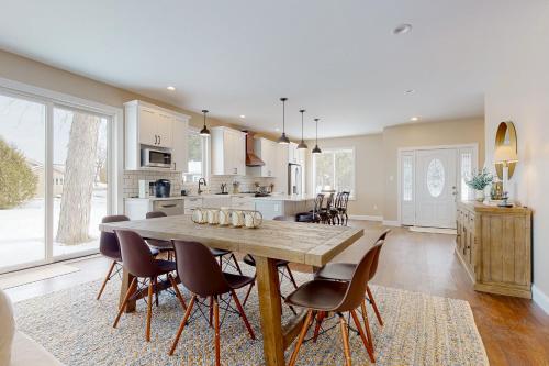 a kitchen and dining room with a wooden table and chairs at Life on the Lake in Colchester