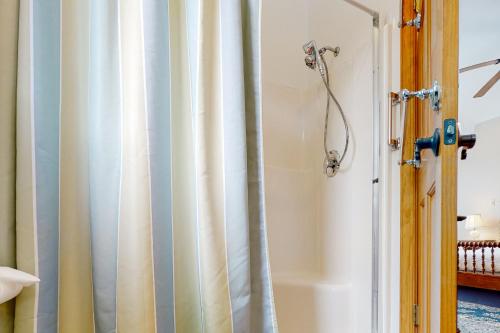 a shower curtain in a bathroom with a tub at Life on the Lake in Colchester