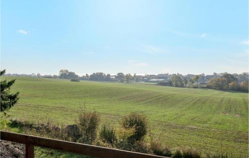 a field of green grass with a wooden fence at Lovely Home In Faaborg With Wifi in Fåborg