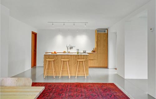 a kitchen with a counter and stools in a room at Lovely Home In Faaborg With Wifi in Fåborg
