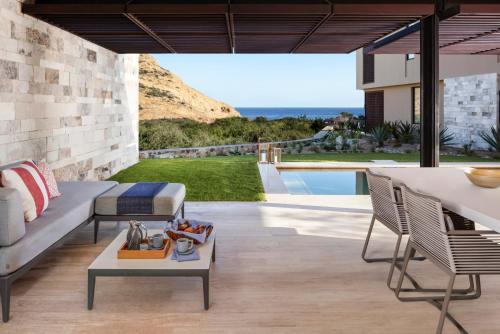 a living room with a couch and a table at Montage Los Cabos in Cabo San Lucas