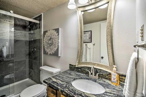 a bathroom with a sink and a mirror and a toilet at Sunset-View Resort Condo on Lake Hamilton! in Hot Springs