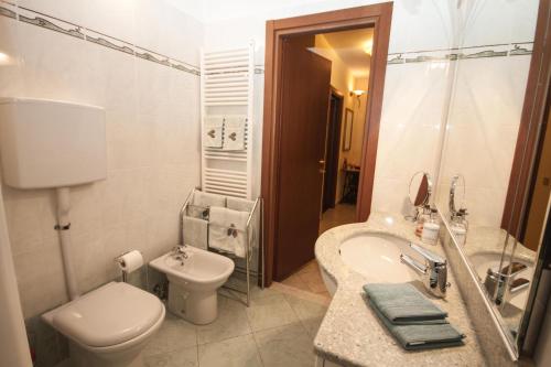 a bathroom with a toilet and a sink at Tremezzo Bella Vista - lake front - lake view in Tremezzo