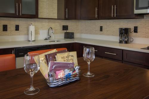 a kitchen table with two wine glasses and a basket of food at Residence Inn Raleigh-Durham Airport/Brier Creek in Raleigh