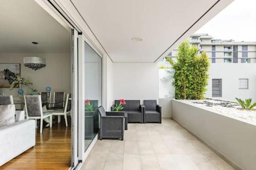 an open living room and dining room with sliding glass doors at Luxury poolside view apartment in Funchal
