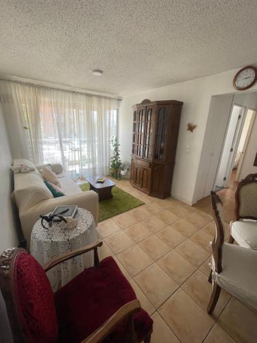 a living room with a couch and a table at Hermoso Depto Jardines in Rancagua