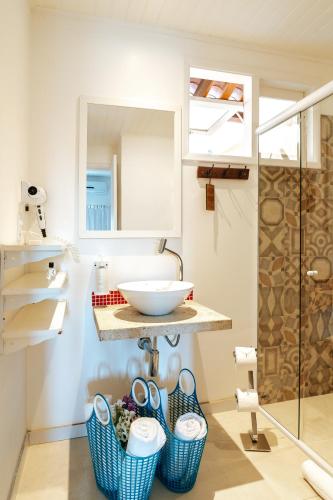 a bathroom with a sink and a mirror at Jubarte Hotel by Insólito in Búzios