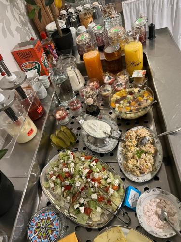a table with many plates of food on it at Hotel Dijkzicht in Oudeschip