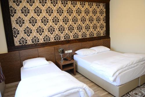 Ein Bett oder Betten in einem Zimmer der Unterkunft Hotel Soydan