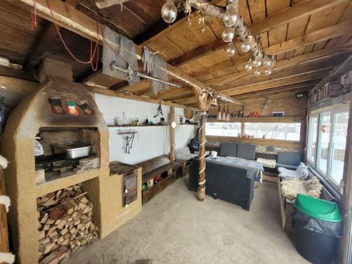 a room with a kitchen with a stove in it at Căsuța din CRAI in Zărneşti