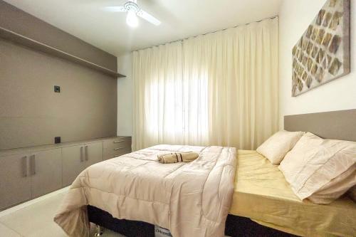 a bedroom with a bed with a white comforter at Casa c piscina em frente ao mar-Barra de Sao Joao in Casimiro de Abreu