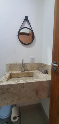 a bathroom with a wooden sink with a mirror at Kbanas Milagres in São Miguel dos Milagres