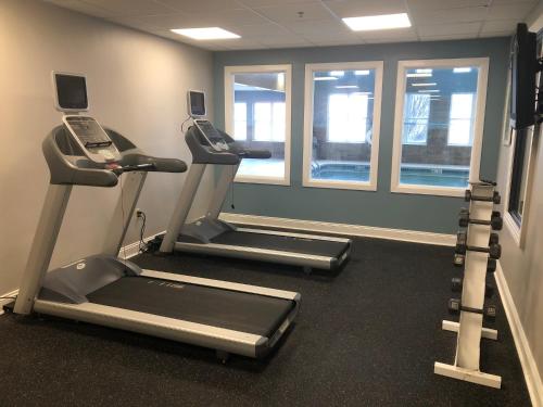a gym with two tread machines and a phone at Country Inn & Suites by Radisson, Gettysburg, PA in Gettysburg