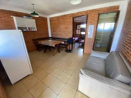 ein Wohnzimmer mit einem Sofa und einem Tisch in der Unterkunft Pousada Residencial Paineiras in Guaratuba