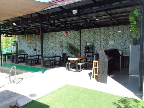 a patio with chairs and a table and a refrigerator at SimoyNorte Private Resort Beneg, Botolan, Zambales, Philippines in Zambales