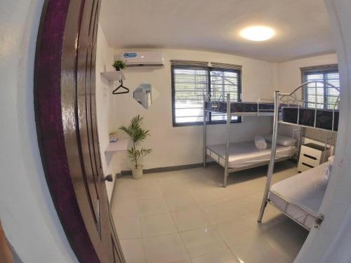a room with two bunk beds and a window at SimoyNorte Private Resort Beneg, Botolan, Zambales, Philippines in Zambales