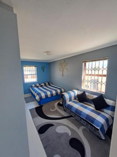 a room with three beds and a carpet at Madeira House in Cape Town