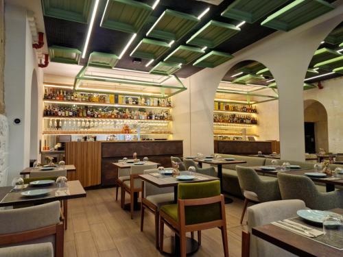a restaurant with tables and chairs and a bar at Porta Nobre Boutique Hotel by Aspasios in Porto