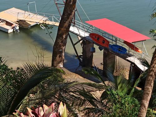 a dock with a surfboard on top of the water at Boca Brava Lodge in Boca Chica