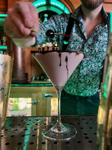 a man is pouring a drink in a martini glass at The Inn at 2nd & C in Eureka