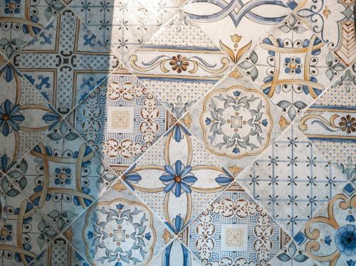 a close up of a wall with blue and white tiles at Capri magic house on the beach in Capri