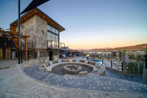 a building with a fire pit in front of it at Sirius Valle in Valle de Guadalupe
