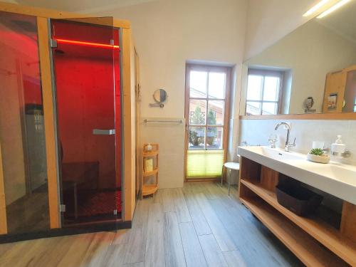 a large bathroom with a shower and a sink at Alpen Chalets Zell am See in Niedernsill