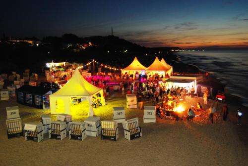a group of tents on the beach at night at Hotel Wald und See in Heringsdorf