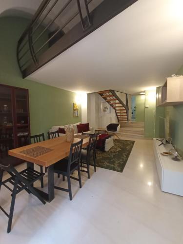 a dining room and living room with a table and chairs at Villetta Marianna in Bari Palese