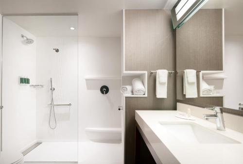 a bathroom with a sink and a shower at Courtyard by Marriott Loveland Fort Collins in Loveland